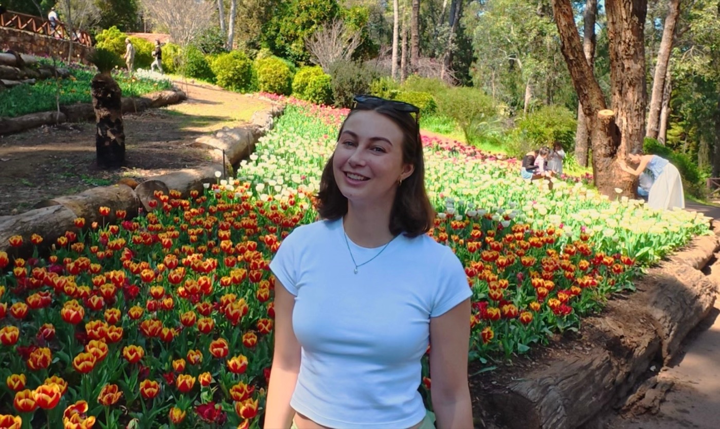 Michelle from Pixly, smiling in a garden of tulips